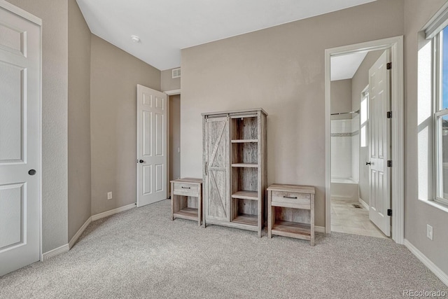 unfurnished bedroom featuring visible vents, carpet, and baseboards