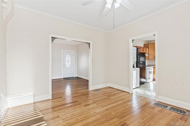 empty room featuring ceiling fan, ornamental molding, and light wood-type flooring