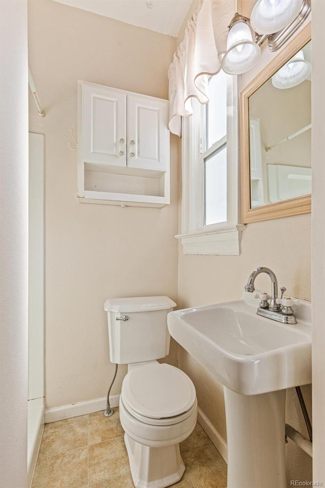 bathroom featuring tile patterned floors, toilet, and sink