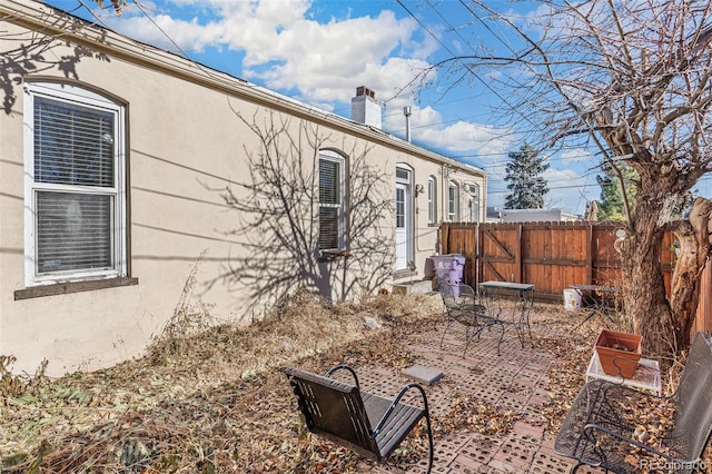 view of side of property featuring a patio