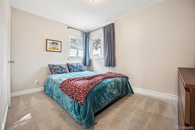 carpeted bedroom with baseboards