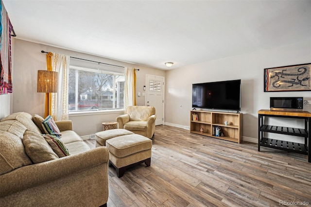 living room featuring wood finished floors and baseboards