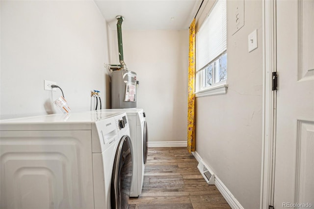 washroom with visible vents, electric water heater, washer and clothes dryer, laundry area, and wood finished floors