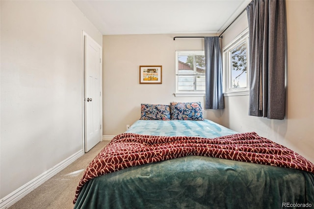 bedroom featuring carpet and baseboards