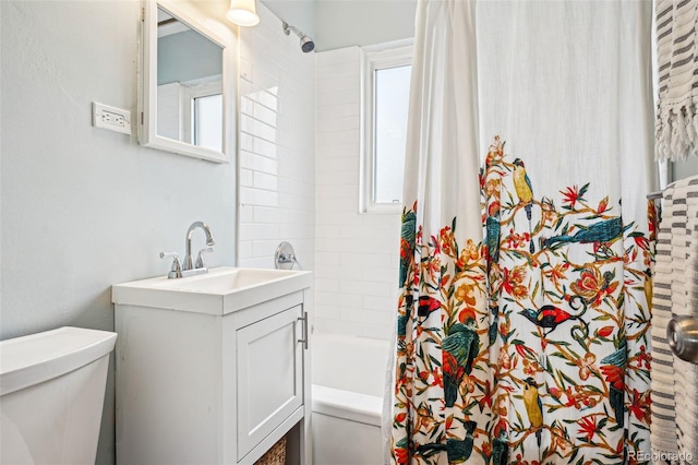 bathroom with toilet, shower / bath combo, and vanity