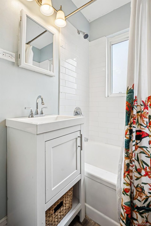 full bathroom featuring vanity and shower / bathtub combination with curtain