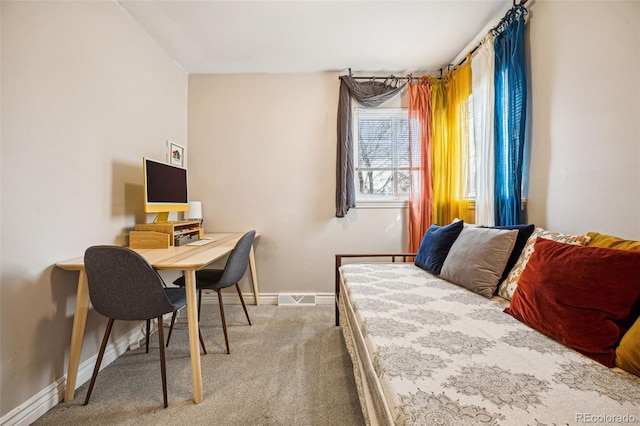 carpeted bedroom with visible vents and baseboards