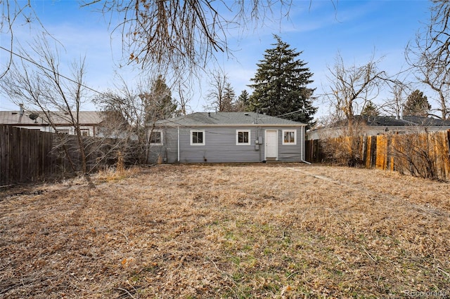 back of property featuring a fenced backyard