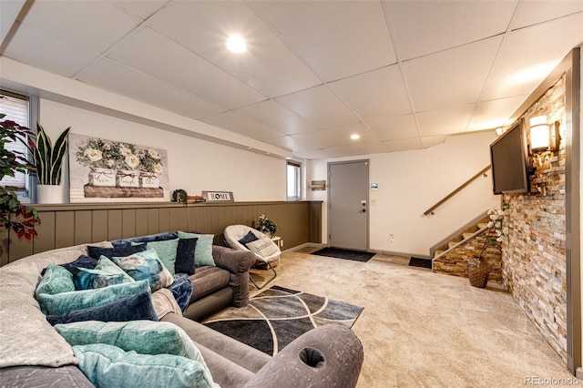 carpeted living area featuring stairway, a drop ceiling, and recessed lighting