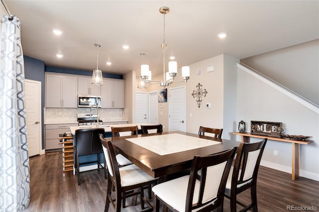 9804 Rosalee Peak St, Littleton, CO 80125 - dining space featuring dark wood-style floors, recessed lighting, a chandelier, and baseboards
