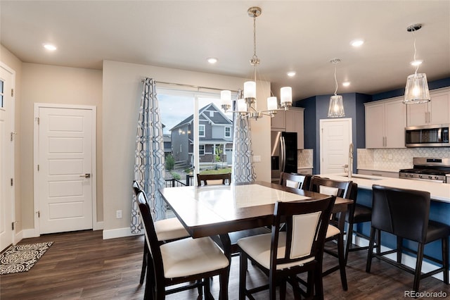 9804 Rosalee Peak St, Littleton, CO 80125 - dining space featuring dark wood-style flooring, baseboards, recessed lighting, and a chandelier