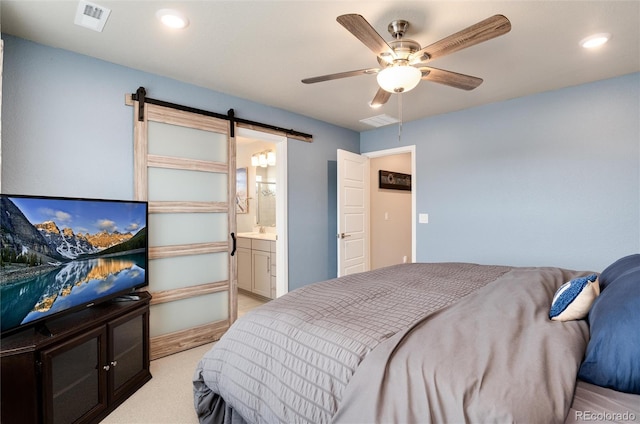 9804 Rosalee Peak St, Littleton, CO 80125 - bedroom with a barn door, a ceiling fan, light colored carpet, recessed lighting, and a sink