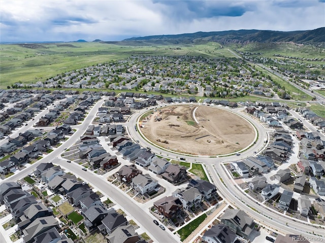 9804 Rosalee Peak St, Littleton, CO 80125 - aerial view of property and surrounding area featuring a mountainous background and nearby suburban area