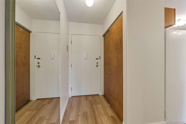 13606 E Bates Ave Unit 304, Aurora, CO 80014 - hallway featuring light wood-type flooring