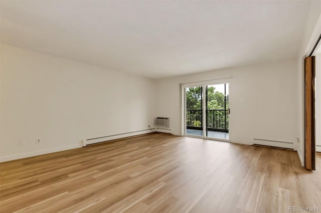 13606 E Bates Ave Unit 304, Aurora, CO 80014 - empty room with baseboard heating, light wood finished floors, an AC wall unit, and baseboards