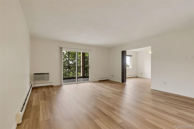 13606 E Bates Ave Unit 304, Aurora, CO 80014 - unfurnished room with baseboard heating, light wood-style flooring, and a wall mounted air conditioner