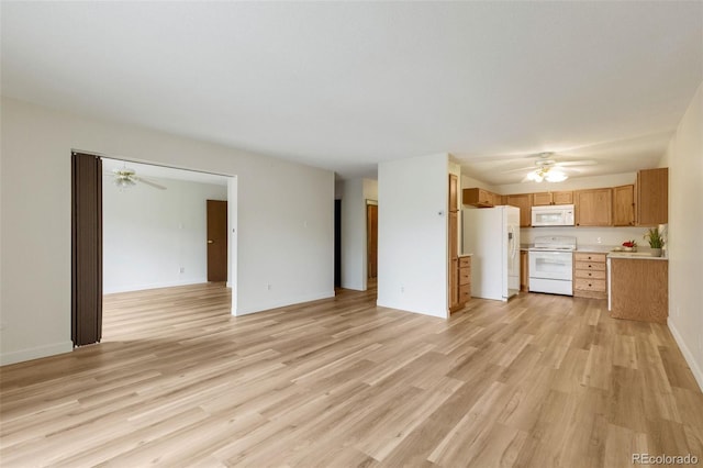 13606 E Bates Ave Unit 304, Aurora, CO 80014 - unfurnished living room with a ceiling fan, light wood-type flooring, and baseboards