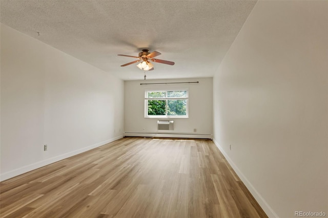 13606 E Bates Ave Unit 304, Aurora, CO 80014 - spare room with a baseboard radiator, a ceiling fan, light wood-style flooring, a textured ceiling, and baseboards