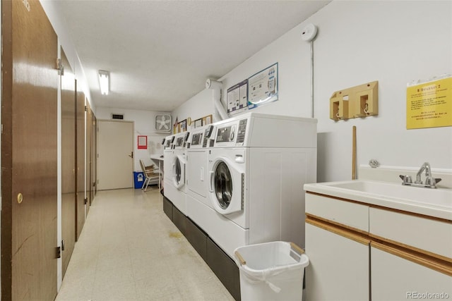 13606 E Bates Ave Unit 304, Aurora, CO 80014 - communal laundry room featuring washing machine and clothes dryer