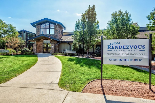 13606 E Bates Ave Unit 304, Aurora, CO 80014 - view of front facade featuring a front yard, stone siding, and french doors