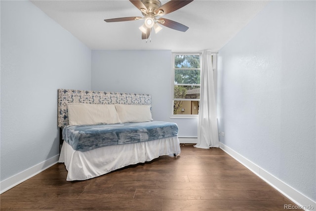 2281 Vaughn Unit 104A, Aurora, CO 80014 - bedroom with a baseboard heating unit, wood finished floors, and baseboards
