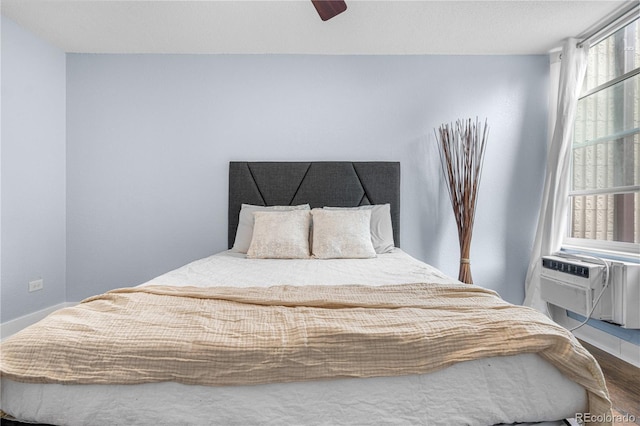 2281 Vaughn Unit 104A, Aurora, CO 80014 - bedroom with a ceiling fan, wood finished floors, baseboards, and cooling unit