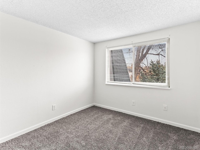 unfurnished room with carpet floors, a textured ceiling, and baseboards