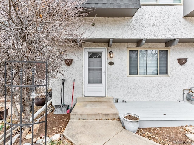 view of exterior entry with stucco siding