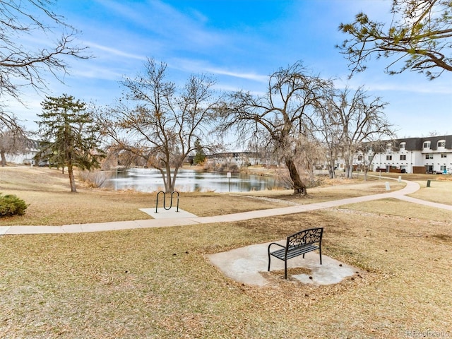 view of home's community featuring a water view and a lawn