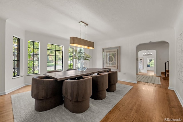 dining area featuring light hardwood / wood-style flooring and a textured ceiling