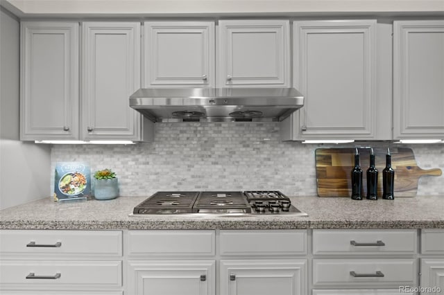 kitchen with white cabinetry, stainless steel gas cooktop, and backsplash