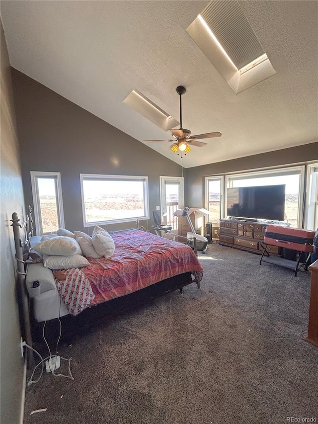 bedroom with a textured ceiling, dark carpet, ceiling fan, and lofted ceiling