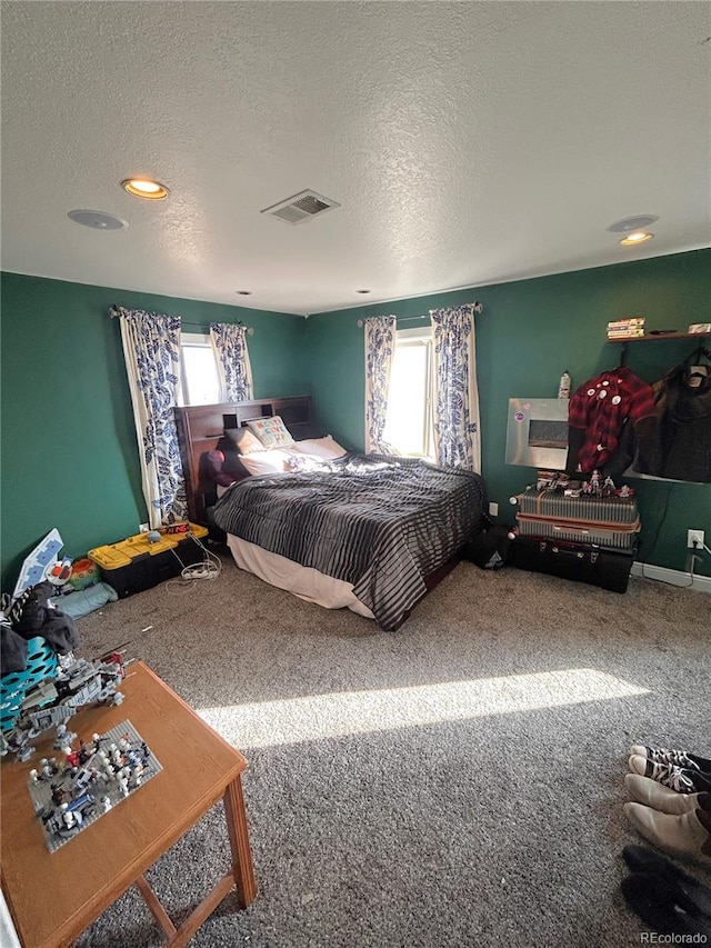 bedroom featuring carpet and a textured ceiling