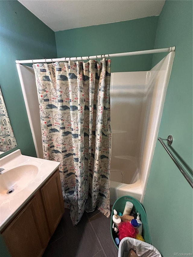 bathroom featuring shower / bath combo and vanity