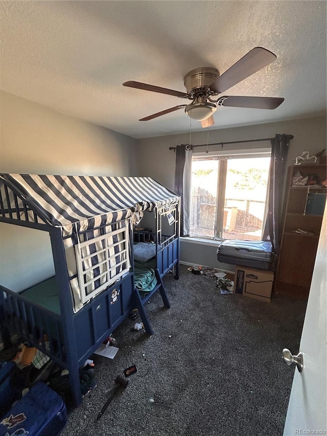 bedroom with ceiling fan and a textured ceiling