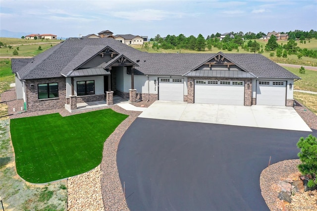 view of front of property with a garage and a front lawn