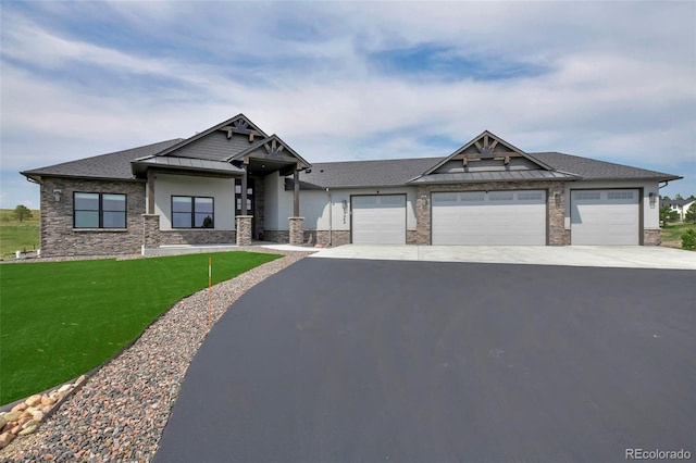 view of front of property featuring a garage and a front yard