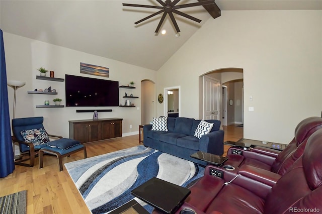 living room featuring beamed ceiling, high vaulted ceiling, and light hardwood / wood-style floors