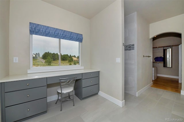 office space featuring light tile patterned floors and built in desk