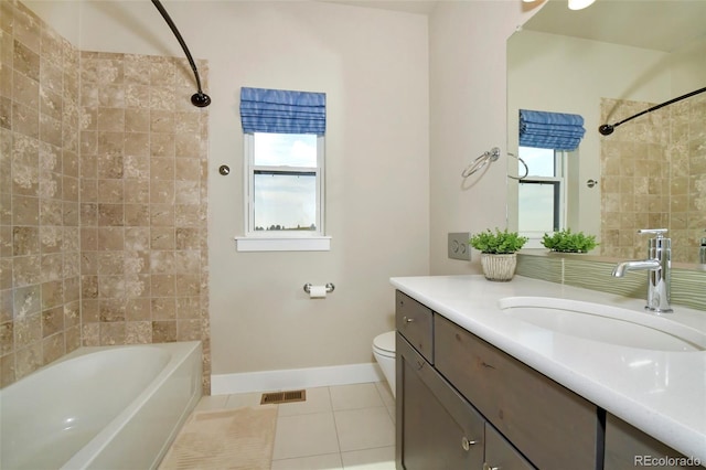 full bathroom with vanity, tiled shower / bath combo, tile patterned floors, and toilet