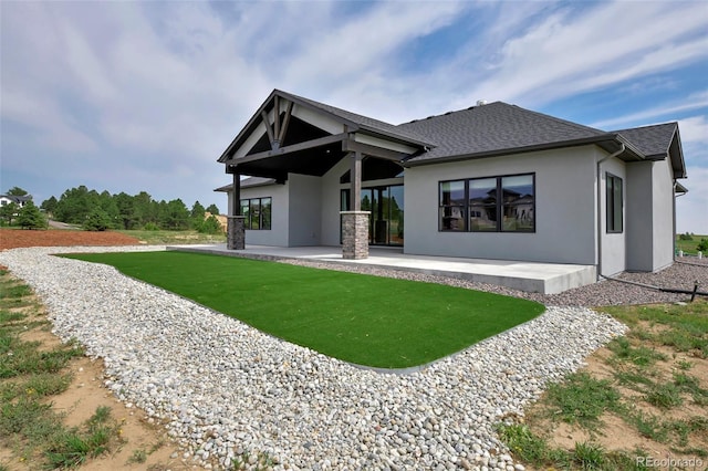 rear view of property featuring a yard and a patio