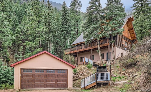 view of front of property featuring a garage and a deck