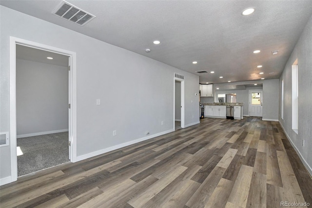 228 E Las Vegas St, Colorado Springs, CO 80903 - unfurnished living room with recessed lighting, dark wood-style flooring, and baseboards