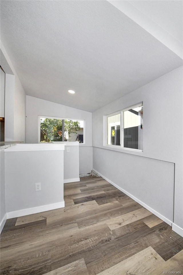 228 E Las Vegas St, Colorado Springs, CO 80903 - empty room featuring wood finished floors, baseboards, recessed lighting, and lofted ceiling