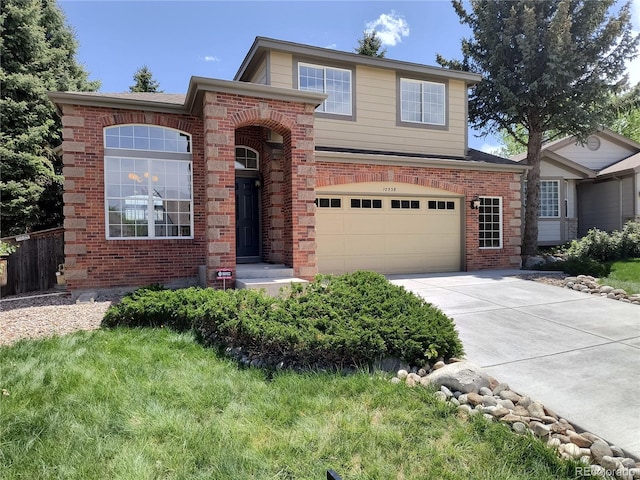 traditional-style home with brick siding, concrete driveway, a garage, and fence