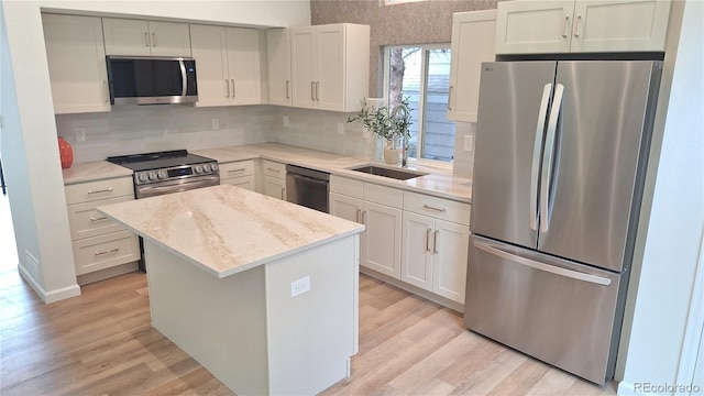 10538 Tiger Chase, Lone Tree, CO 80124 - kitchen with stainless steel appliances, a center island, light wood-type flooring, and backsplash