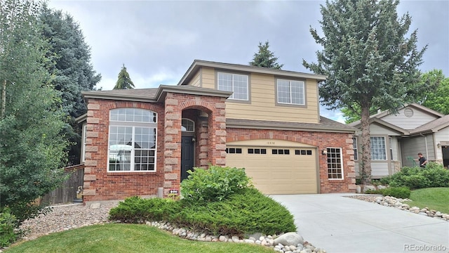 10538 Tiger Chase, Lone Tree, CO 80124 - traditional home with brick siding, driveway, an attached garage, and roof with shingles