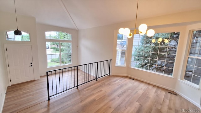 10538 Tiger Chase, Lone Tree, CO 80124 - entryway with a chandelier, wood finished floors, and lofted ceiling
