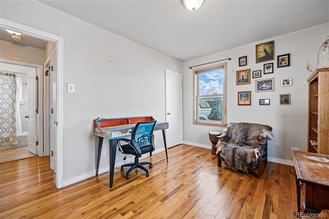 office featuring baseboards and light wood-type flooring