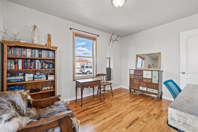 home office with baseboards and light wood-style floors